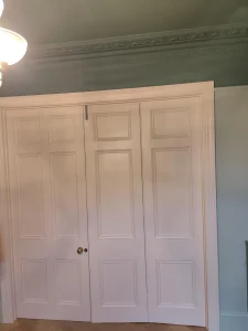 Freshly painted wardrobe doors and wall in Lewisham home