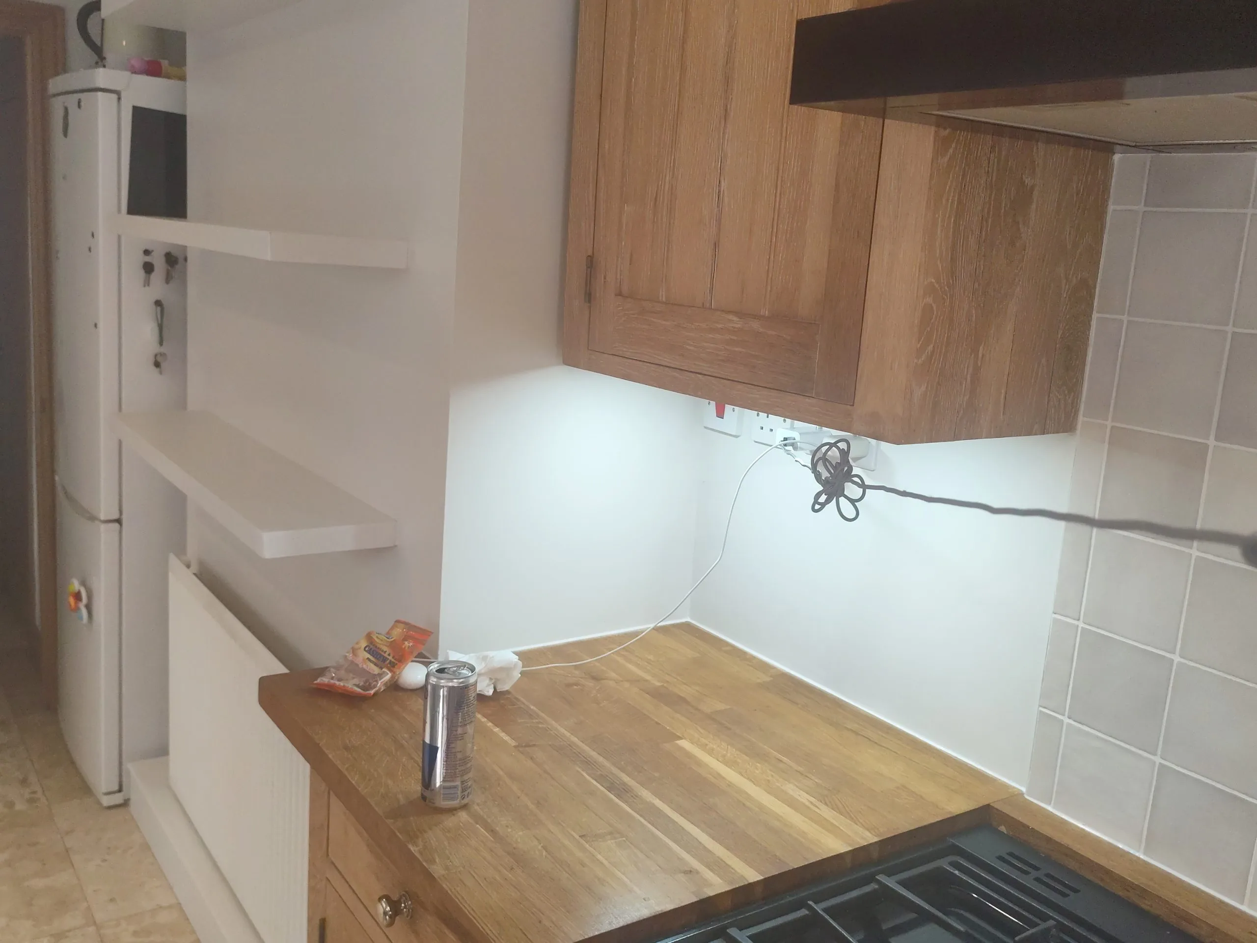 Kitchen painting and cabinet finishing project with wooden countertop and wall repaint