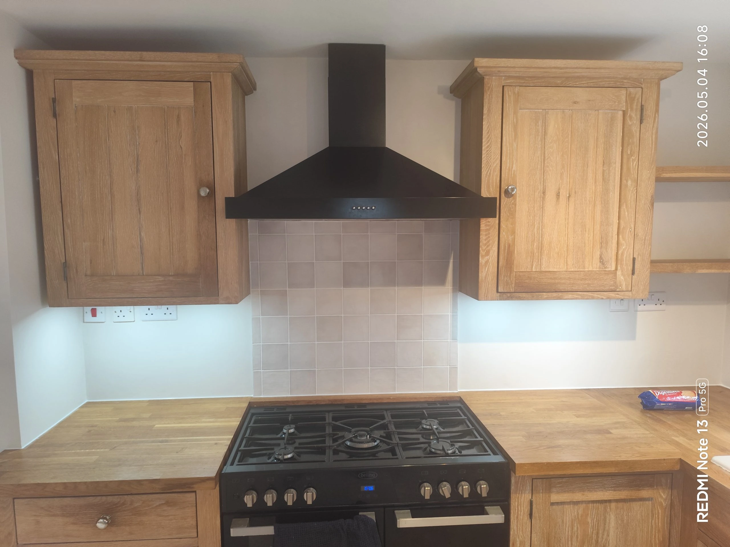 Complete kitchen renovation with wall painting, cabinets, and stove installation