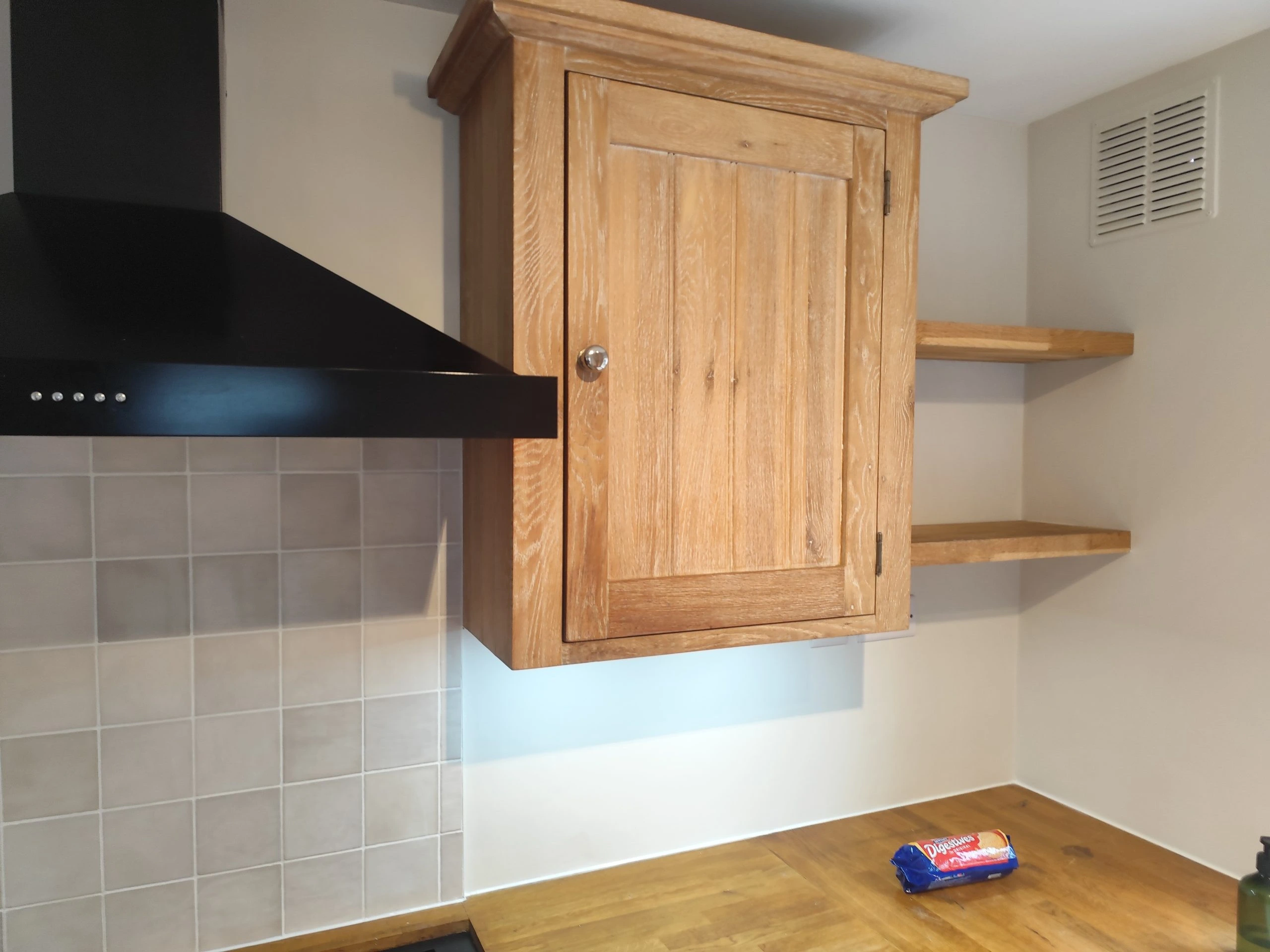 Freshly painted kitchen wall with cabinet installation and modern countertop finish