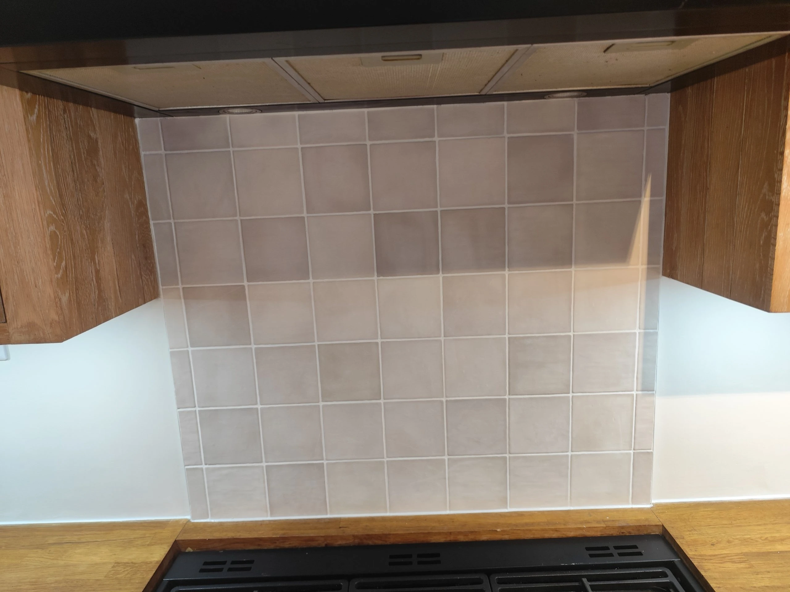 Modern kitchen makeover with painted walls, wooden cabinets, and cooker setup