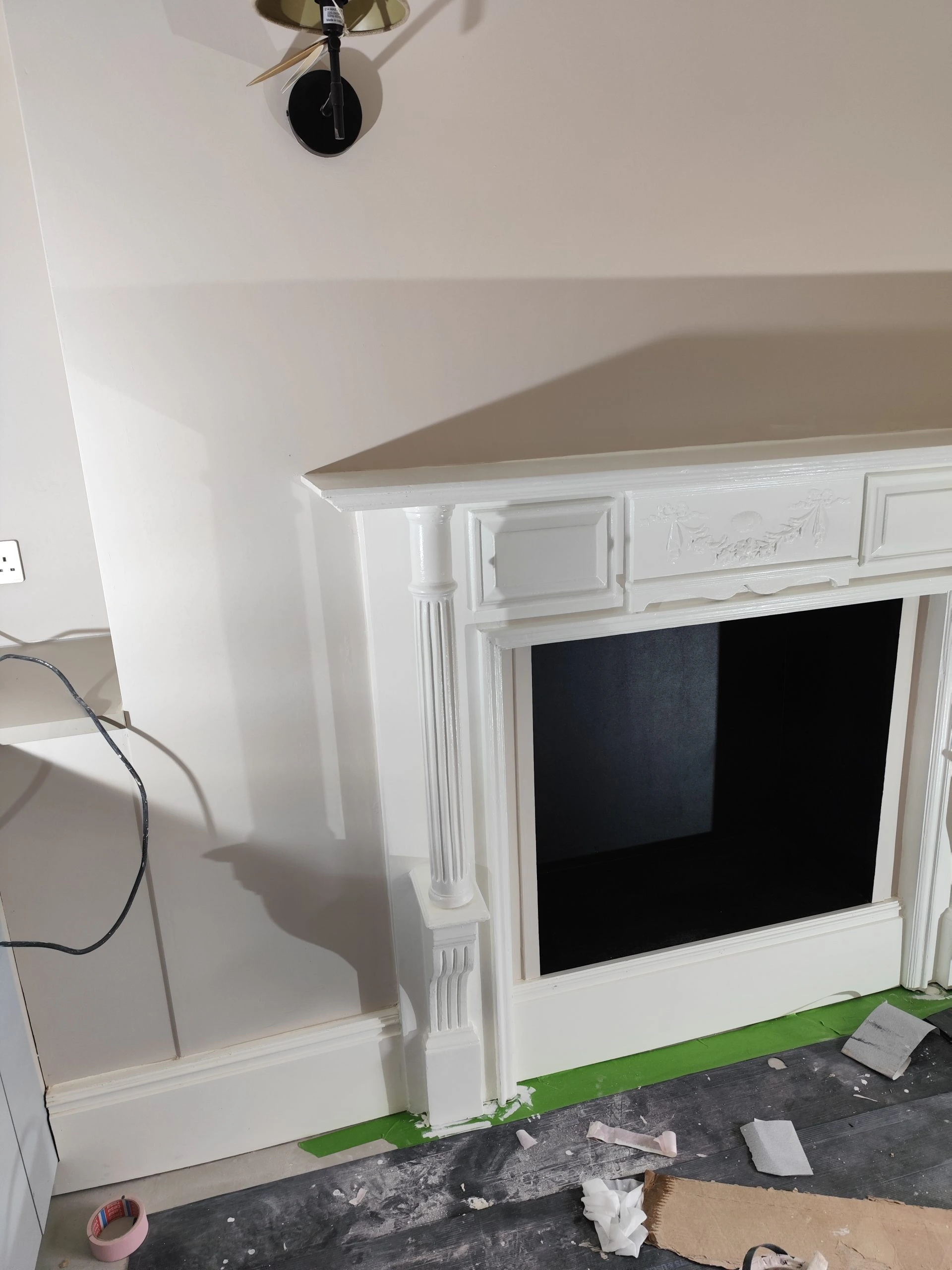 Restored Georgian fireplace surround with decorative panel and column detailing in London