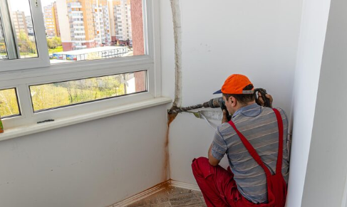 Black mould patch on damp wall in a London flat