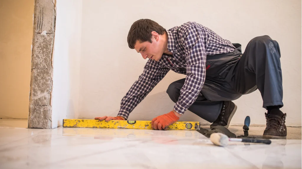 Professional tiler measuring and levelling a tiled floor during a home renovation